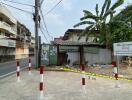 Urban street view showcasing an undeveloped lot with surrounding buildings and infrastructure