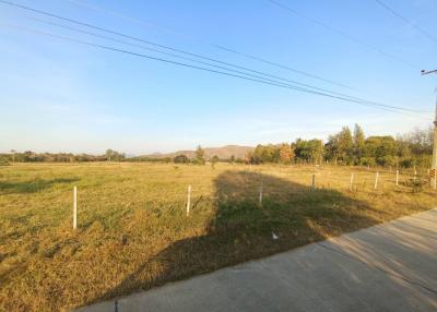 Spacious open land with a clear sky and mountain view, suitable for potential development