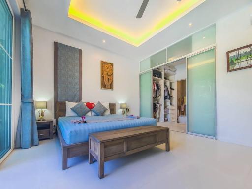 Modern spacious bedroom with en-suite walk-in closet and ambient lighting