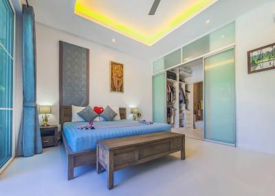 Modern spacious bedroom with en-suite walk-in closet and ambient lighting