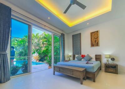 Bright and modern bedroom with a pool view