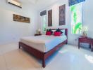 Bright and spacious tropical bedroom with artistic decor