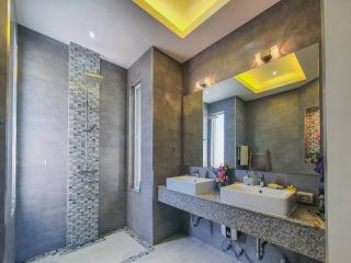 Spacious modern bathroom with a walk-in shower and double sinks