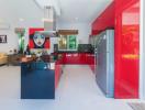 Modern kitchen interior with red cabinets and stainless steel appliances