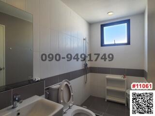 Modern bathroom with white amenities and window