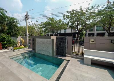 Modern outdoor area with swimming pool and lounging space