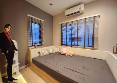 Cozy modern bedroom interior with a large bed and furnishings at dusk