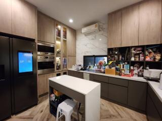 Modern kitchen with wood finished cabinets and built-in appliances