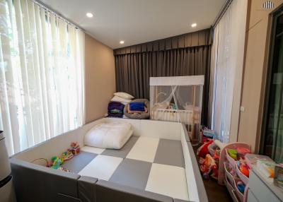 Spacious bedroom with large bed and children
