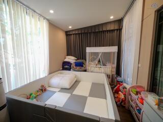 Spacious bedroom with large bed and children