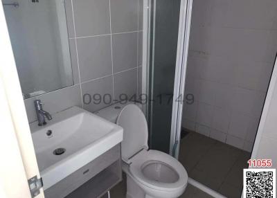Compact bathroom with sink, toilet, and shower