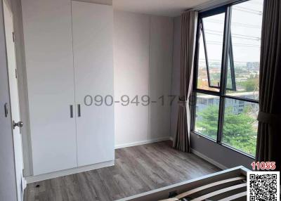 Spacious Bedroom with Large Window and Wardrobe
