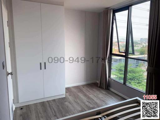 Spacious Bedroom with Large Window and Wardrobe