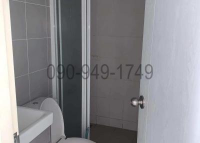 Compact bathroom with glass shower and white toilet