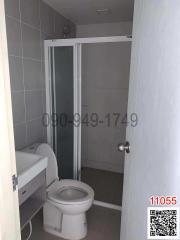 Compact bathroom with glass shower and white toilet