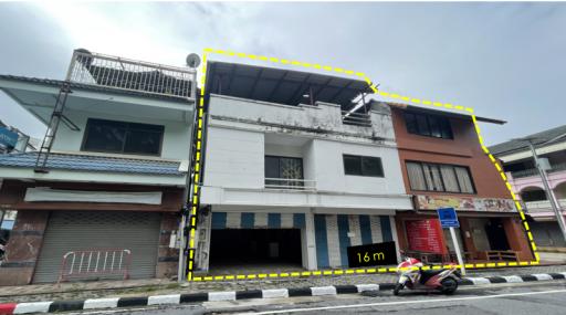 Three-story commercial-residential hybrid building with storefronts on the ground floor and potential living spaces above.