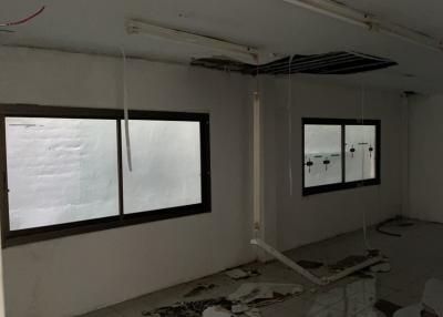 Unfinished interior space with large windows and exposed wiring
