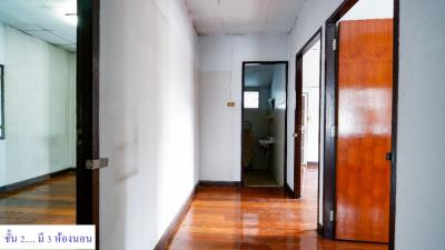 Spacious hallway with polished wooden floors and multiple doors leading to different rooms