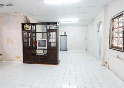 Spacious unfurnished living room with tiled flooring and multiple windows