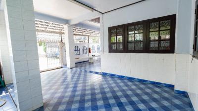 Spacious and well-lit tiled porch area with large windows and white walls