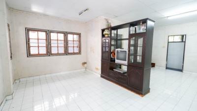 Spacious unfurnished living room with tiled flooring and multiple windows