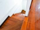 Wooden staircase inside a home leading downwards