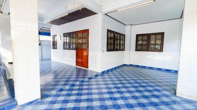 Spacious interior room with blue-patterned tiled flooring and ample natural light