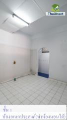 Empty white and blue tiled bathroom with visible plumbing installations