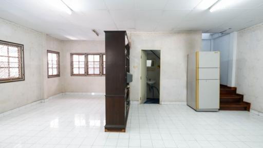 Spacious kitchen with white tiles and natural light