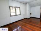 Spacious unfurnished living room with hardwood floors and ample natural light