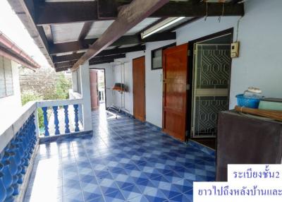 Spacious balcony with blue tiles and a view of the outdoors