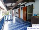 Spacious balcony with blue tiles and a view of the outdoors