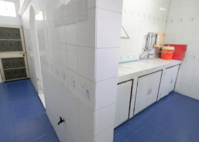 Spacious kitchen with blue flooring and white cabinetry