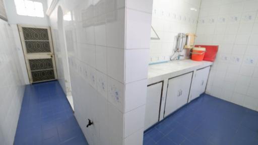 Spacious kitchen with blue flooring and white cabinetry