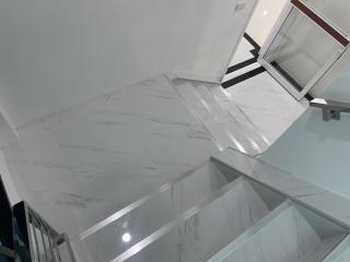 Modern marble staircase with glass railing