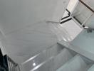 Modern marble staircase with glass railing