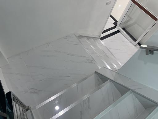 Modern marble staircase with glass railing