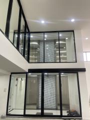 Modern two-story building interior with glass partitions and LED lighting