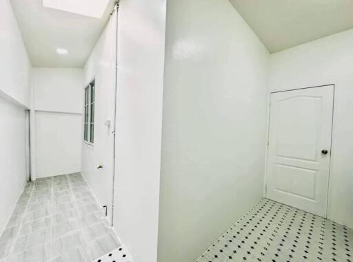 Bright and spacious corridor leading to rooms with patterned tiled flooring