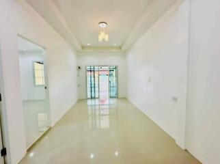 Spacious and bright empty living space with glossy tiled flooring