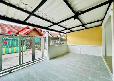 Enclosed patio area with tiled flooring and a clear view of the surrounding neighborhood