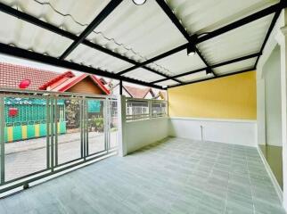 Enclosed patio area with tiled flooring and a clear view of the surrounding neighborhood