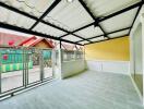 Enclosed patio area with tiled flooring and a clear view of the surrounding neighborhood