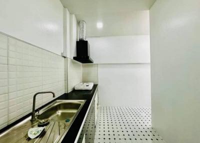 Modern monochromatic kitchen with stainless steel details