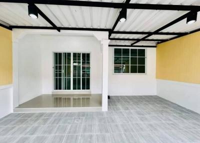 Empty living space with gray flooring and yellow walls