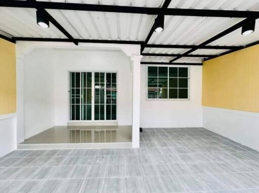 Empty living space with gray flooring and yellow walls