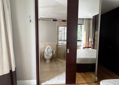 View from bedroom into an en-suite bathroom with sliding door
