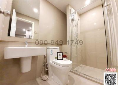 Modern bathroom with glass shower enclosure and neutral color palette