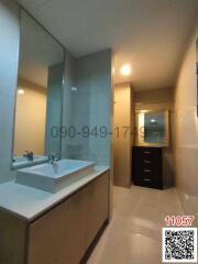 Modern bathroom with large mirror and vanity