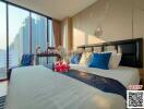 Modern bedroom with a large bed, city view, and decorative elements